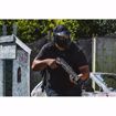 Paintball player on course holding T4E TB 68 PAINTBALL MARKER - .68 CAL-BLACK